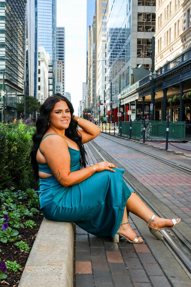Senior in a teal dress on a downtown street