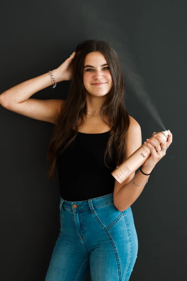 Studio styling shot in a black tank and denim