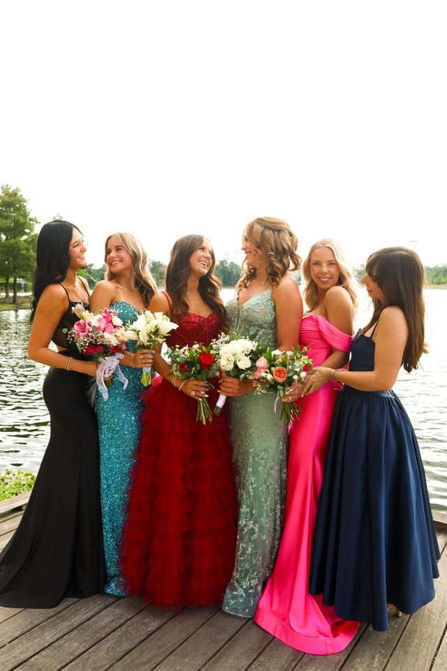 Group of friends in formal gowns on a dock