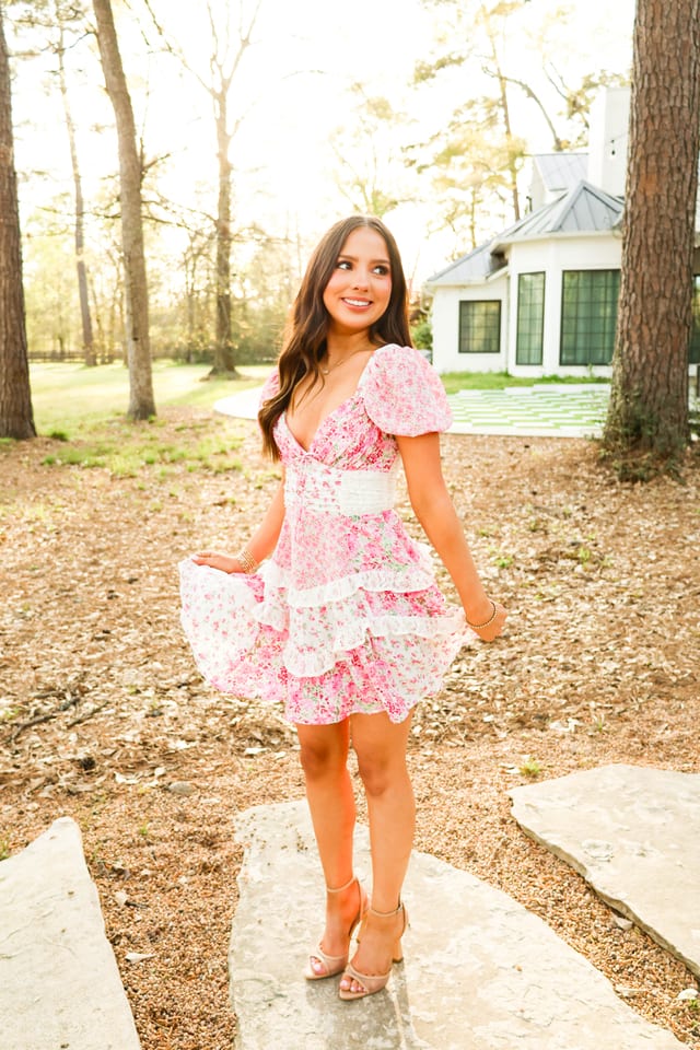 Senior portrait in a pink floral dress at golden hour