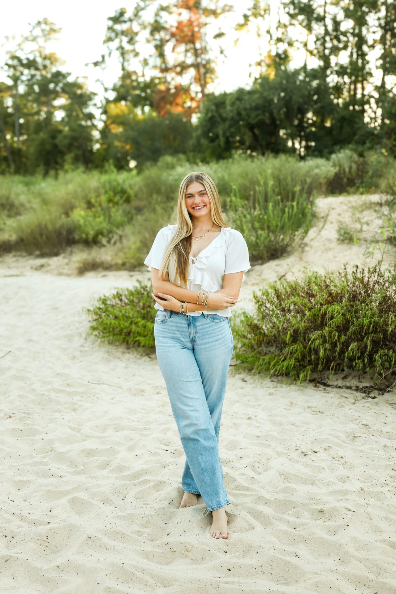 Senior in a white top on a sandy beach