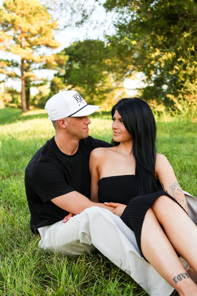 Couple in jeans and white tops, downtown Houston backdrop