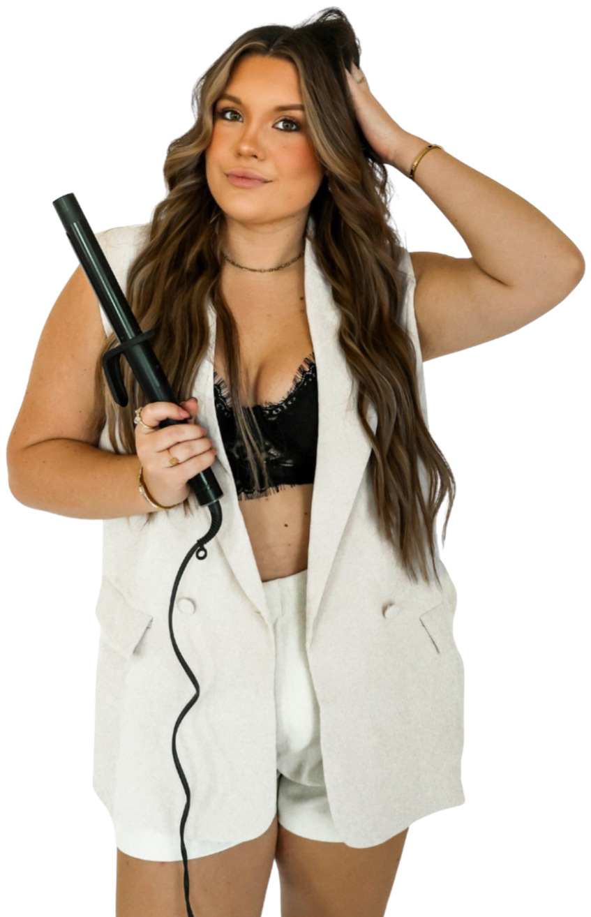 Madi Atkisson holding a curling iron, beachy waves on display