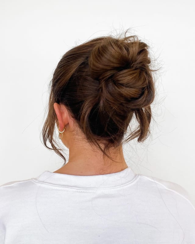 Textured high updo with face-framing pieces