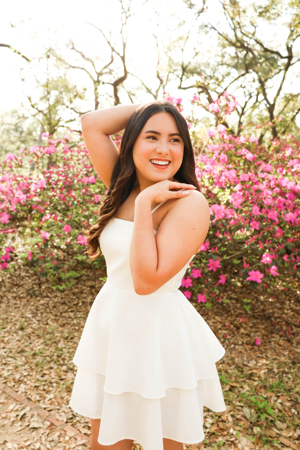 Senior in white dress with azaleas