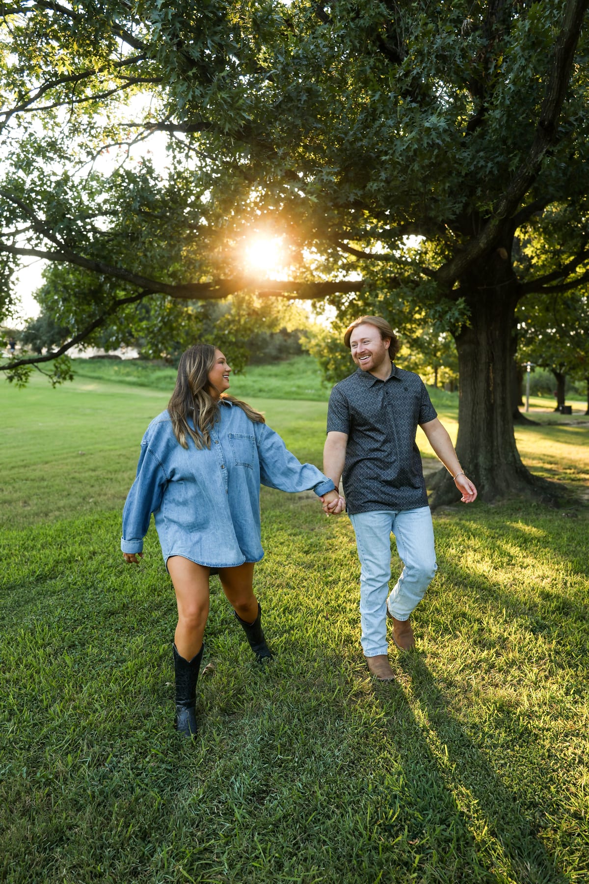 Couple walking through sunlit field