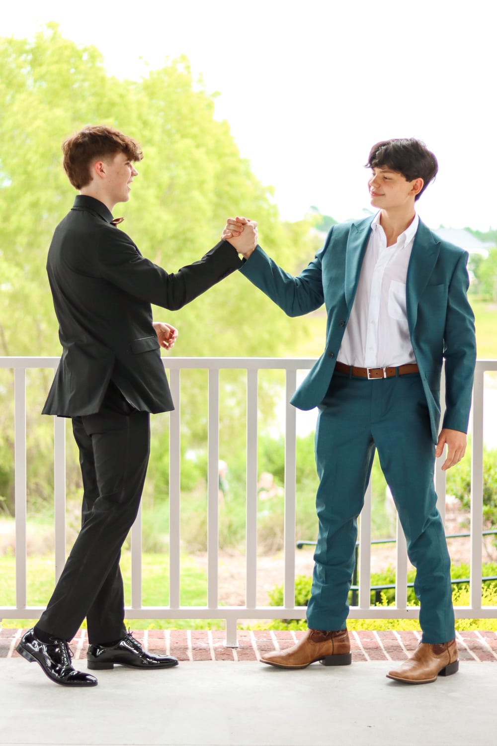 Two senior guys in suits celebrating