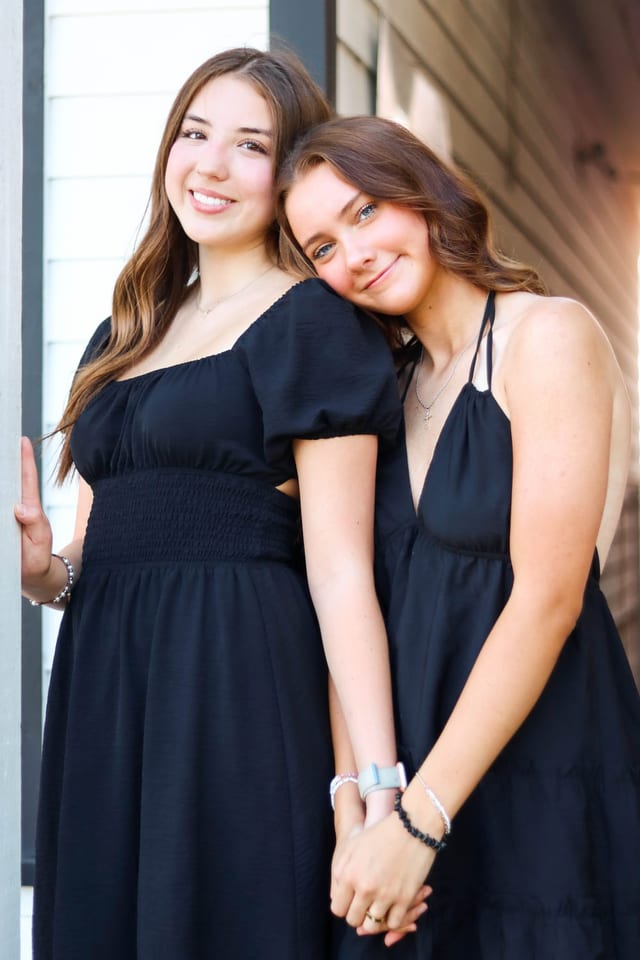 Two sisters in matching dresses